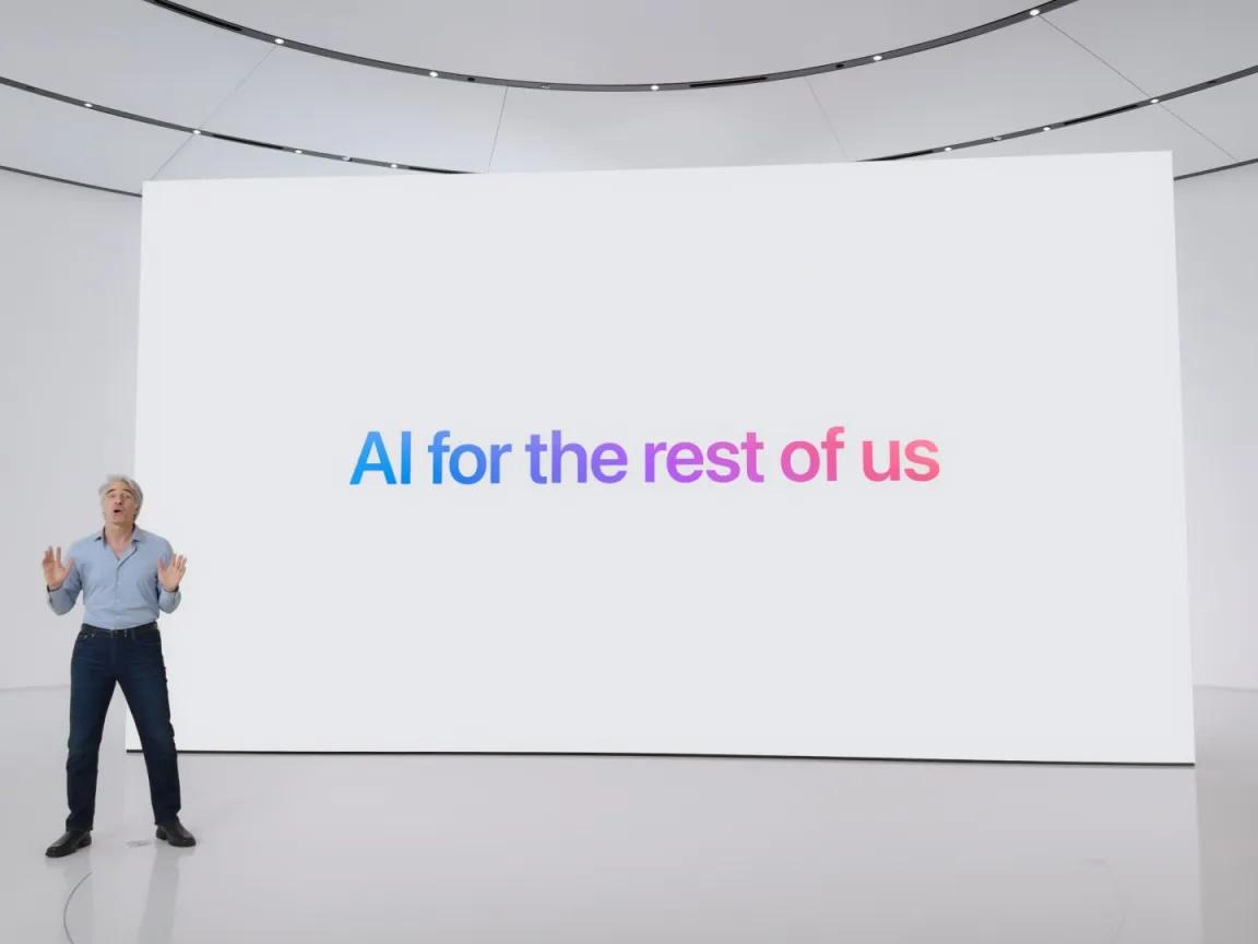 A person stands on a large, minimalist stage next to a screen displaying the phrase "AI for the rest of us" in colorful text.